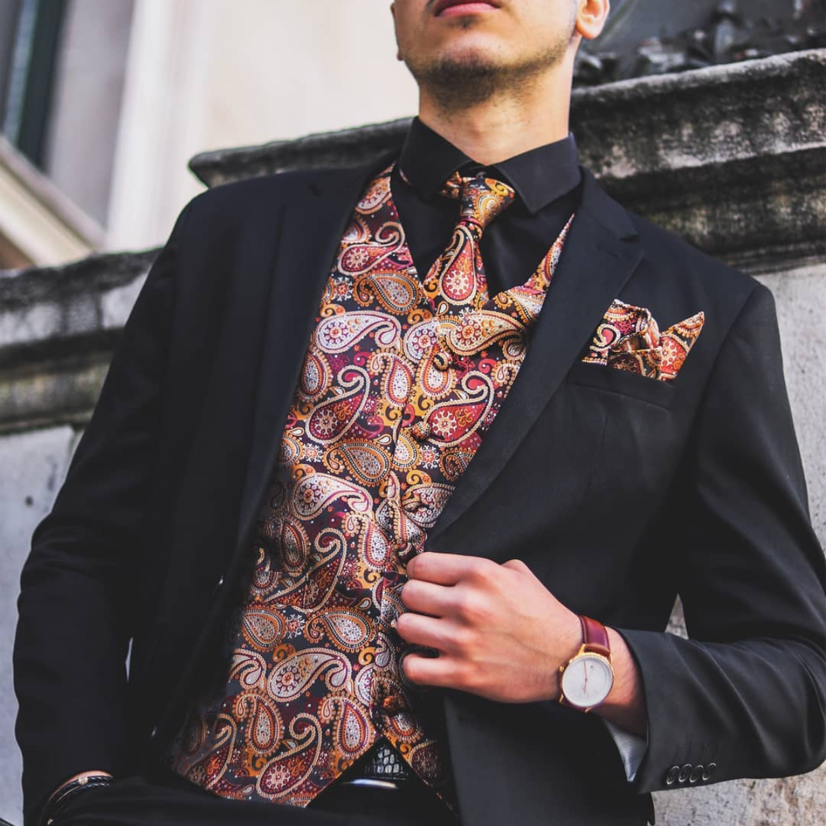Men wearing paisley vest and black suit